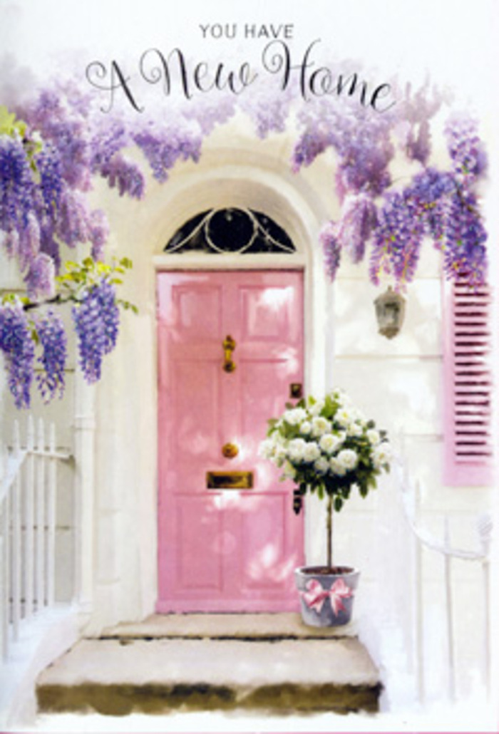 The scene shows a tranquil Collier Row doorway that looks ready to welcome someone home for the very first time. A pretty pink front door, painted in a soft pastel shade, forms the heart of the image, its colour delicately echoed in the single shutter beside it. Around and above, generous cascades of wisteria drape in velvety lavender clusters, their blossoms hanging like soft curtains that brush the edges of the whitewashed wall. The wisteria appears to have grown and settled over many seasons, creating a sense of rootedness and continuity that contrasts beautifully with the idea of a fresh start in a new house. On the threshold sits a stylish grey bucket, the kind a Collier Row florist might choose for a chic yet homely doorstep display for a family moving close to Havering Country Park or around the quiet streets near Chase Cross. From the bucket overflows a lush bouquet of creamy white roses, each bloom fully open and plush, with subtle touches of green foliage weaving between them. A satin-finish pink ribbon wraps around the container, mirroring the soft pink of the door and adding a gentle, celebratory detail. The lighting is calm and generous, perhaps a mild spring afternoon, with highlights on the petals and shadows dancing along the stone step. Everything about the image-from the colours and textures to the way the flowers are composed-evokes that tender mix of excitement, nostalgia, and hope that comes with settling into a new home, as though the flowers themselves are offering comfort and a heartfelt, floral blessing for the life to unfold within.